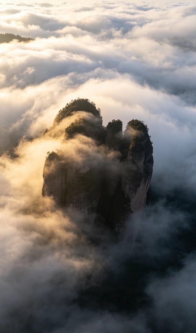 The three Danxia peaks of Jianglang Shan wrapped in morning cloud.